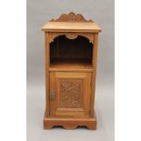 A Victorian carved walnut pot cupboard. 39 cm wide.