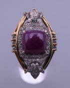 An unmarked gold cabochon ruby and diamond ring. Ring size G/H.