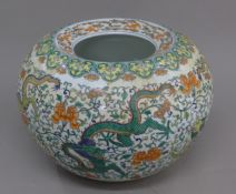 A large Chinese porcelain jardiniere decorated with dragons. 23 cm high.