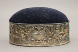 A silver mounted oval pin cushion. 11.5 cm wide.