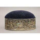 A silver mounted oval pin cushion. 11.5 cm wide.