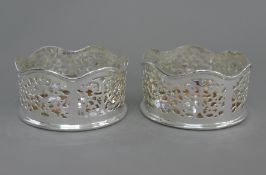 A pair of silver plated coasters. 12.5 cm diameter.