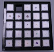 A cased set of gemstones (one lacking).