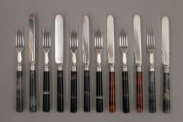 Six agate handled knives and forks.