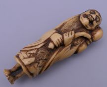 A 17th/18th century Japanese carved stag horn netsuke of a sage. 7 cm high.