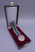A boxed Women's Voluntary Service medal.