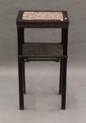 A late 19th century Chinese marble inset topped wooden stand. 80 cm high.