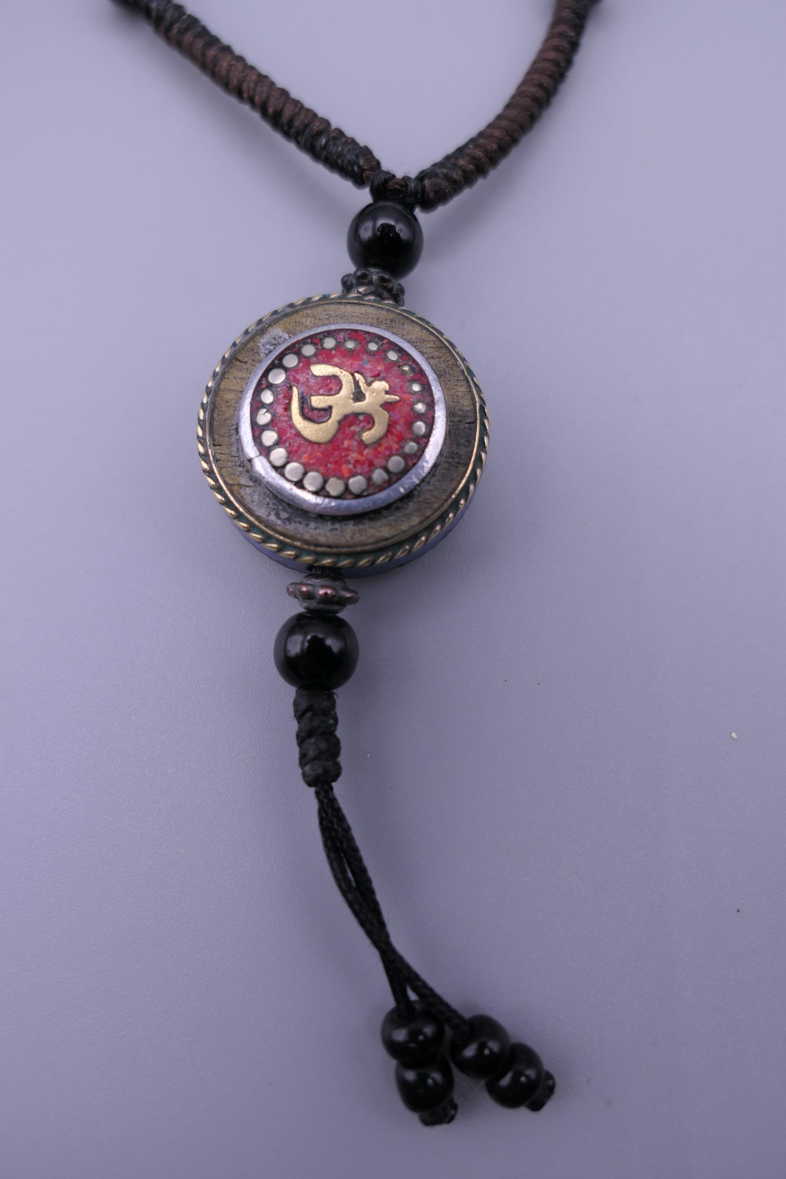 A Tibetan necklace and an African glass bead necklace. - Image 2 of 4