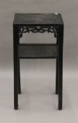 A late 19th century Chinese ebonised carved wooden stand. 80 cm high.