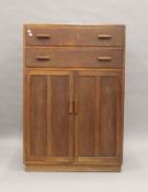 A 20th century two door and two drawer cupboard. 83 cm wide.