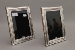A pair of silver photograph frames. 22 cm high.