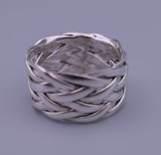 A silver puzzle ring.