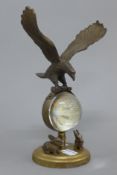 An eagle form ball clock. 21.5 cm high.