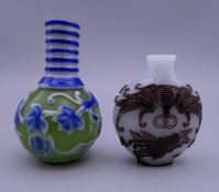 Two Chinese cameo glass snuff bottles. The largest 6.5 cm high.