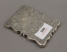 An ornate silver card case engraved with overall foliate design, hallmarked Birmingham 1907.