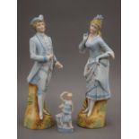 A 19th century pair of Continental bisque figurines of an 18th century couple in blue and white