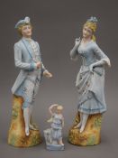 A 19th century pair of Continental bisque figurines of an 18th century couple in blue and white