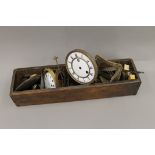 A vintage pine engineer's divided box containing a quantity of clock parts, including springs,