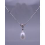 An 18 ct white gold pearl and diamond necklace. The chain 45 cm long.