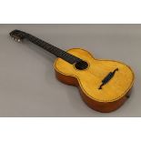 An antique inlaid parlour guitar.