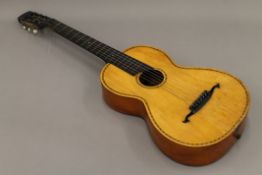 An antique inlaid parlour guitar.