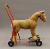 A vintage Lines Brothers push along child's pony. 57 cm long.