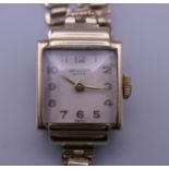 A 9 ct gold Universal Geneve ladies wristwatch on a gold plated bracelet, in working order.