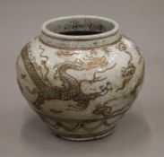 A Korean white pottery jardiniere decorated with dragons. 21 cm high.