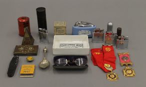 A quantity of various items, including lighters, tins, etc.