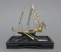 A Chinese silver model of a junk. 15 cm high.