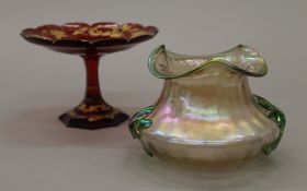 A Leotz type iridescent glass vase and a gilded ruby glass tazza. The latter 10.5 cm high.