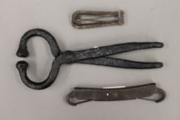 A vintage iron bull leader and two horse bits. The former 23.5 cm long.