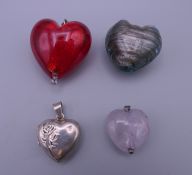 Four various heart pendants. The largest 3 cm high.