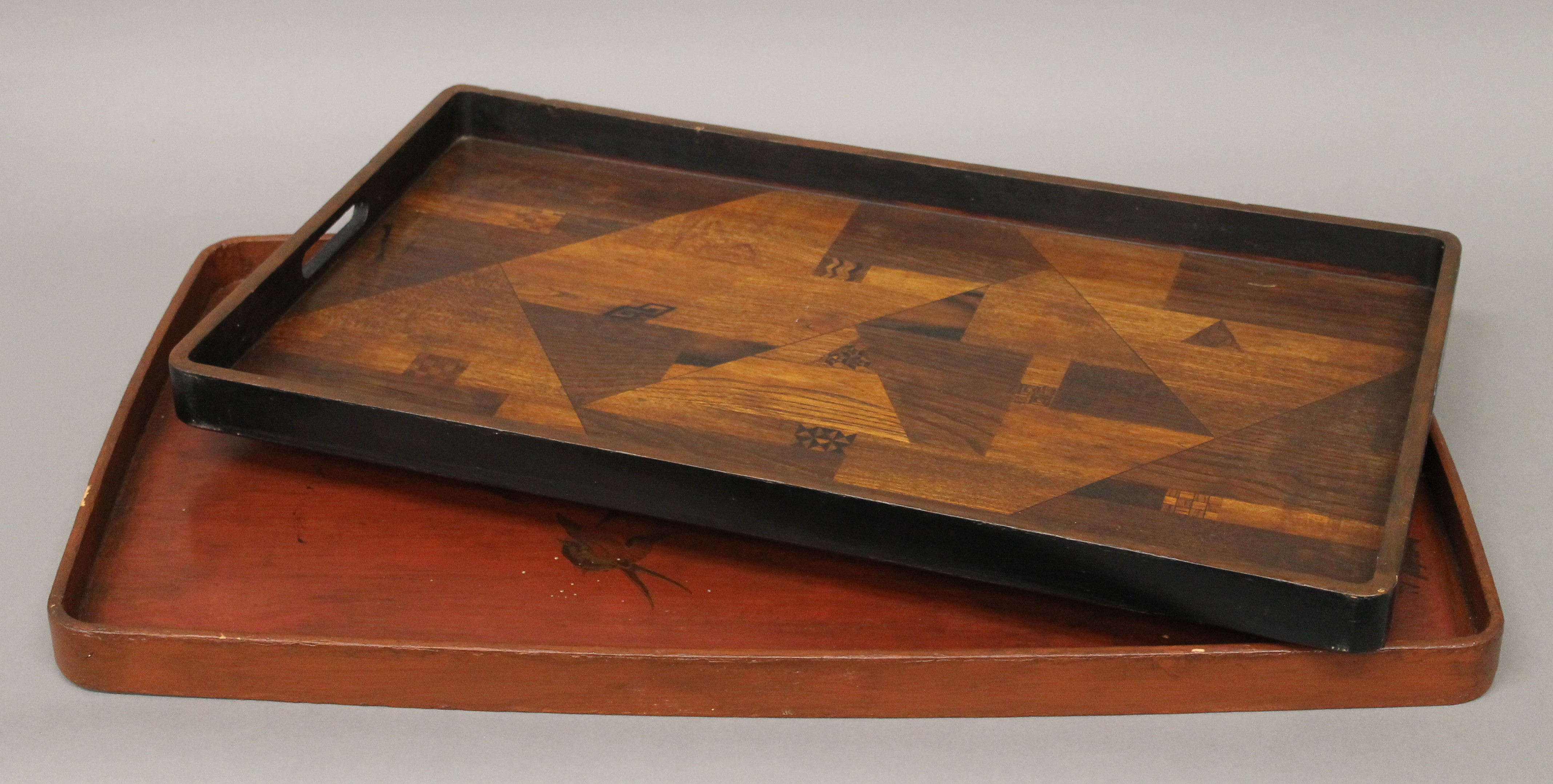 Two Japanese trays, one inlaid and one lacquered. The former 68 cm wide.