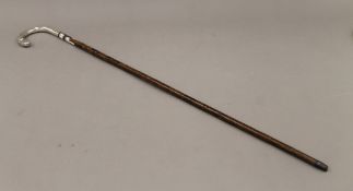 A silver handle partridge wood walking stick. 92 cm long.