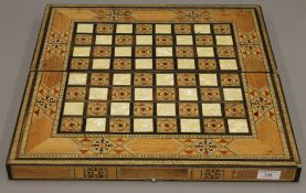 An Eastern inlaid chess and back gammon box. 49 cm wide.