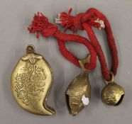 A brass box and two bells. The former 9 cm long.