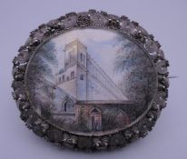 A 19th century unmarked silver filigree brooch set with a miniature painting on ivory. 6.5 cm wide.