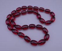 A string of beads. 82 cm long.