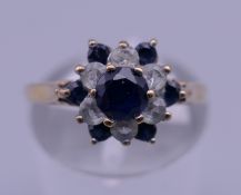 A 9 ct gold flower head ring. Ring size L/M. 1.8 grammes total weight.