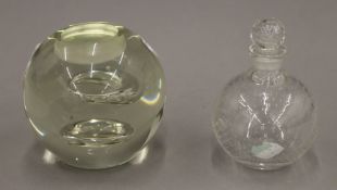 A glass scent bottle and a glass tealight holder. The former 9.5 cm high.