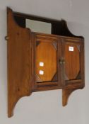 A Victorian walnut wall cabinet.