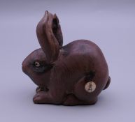 A wooden netsuke formed as a rabbit. 5 cm high.