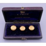 A cased set of three 18 ct gold shirt studs. 3.6 grammes.