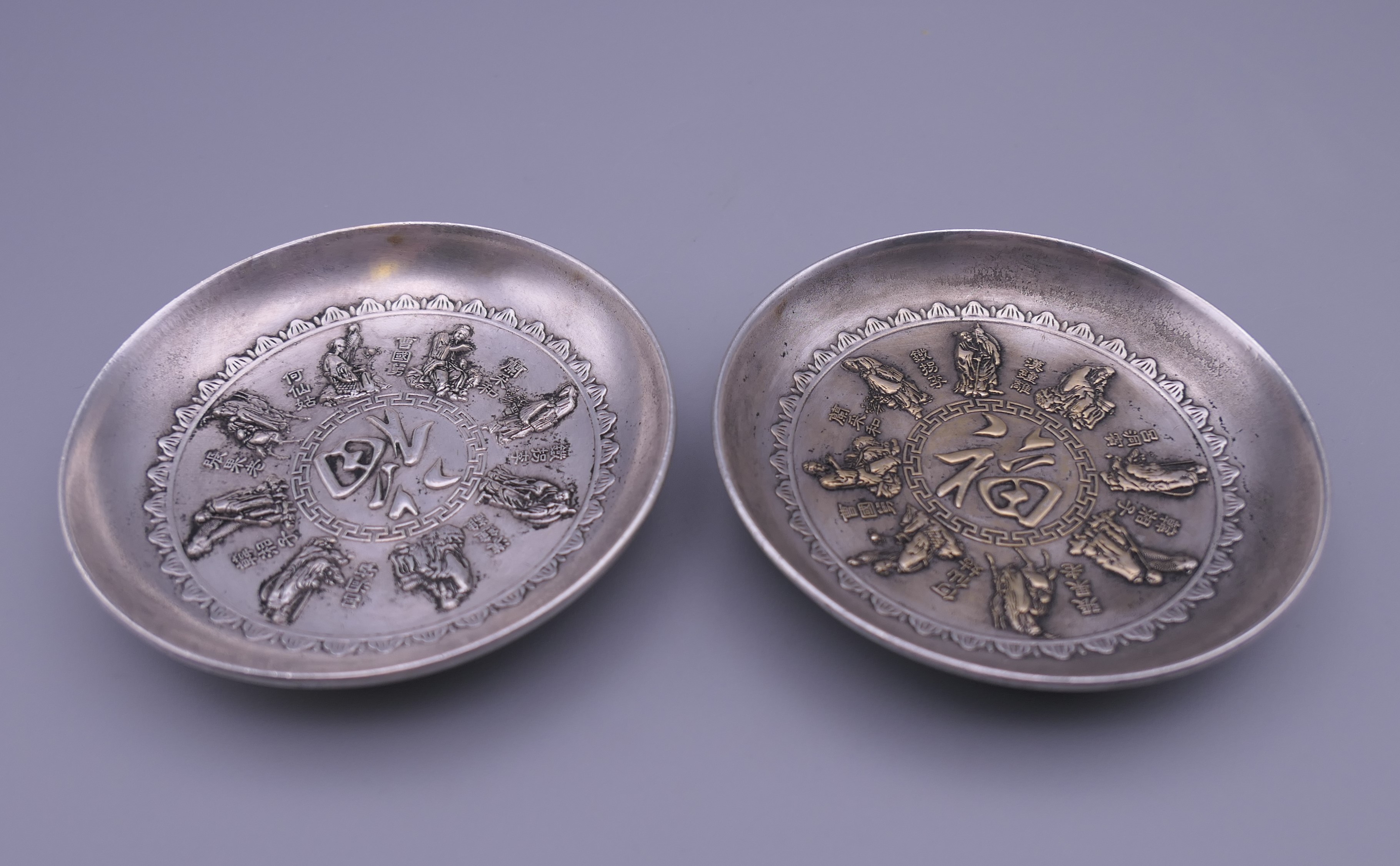 Two Chinese white metal dishes. Each 9 cm diameter.