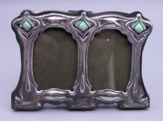 A silver double photograph frame. 11 cm wide.