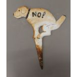 A cast iron dog sign.