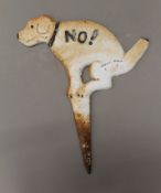 A cast iron dog sign.