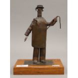 An interesting vintage copper sculpture of a butcher on a wooden base in the school of Wallace and