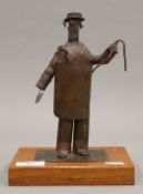 An interesting vintage copper sculpture of a butcher on a wooden base in the school of Wallace and
